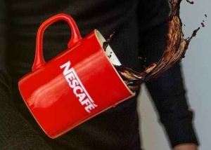 photo of man tossing nescafe mug