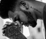 man tattooed praying